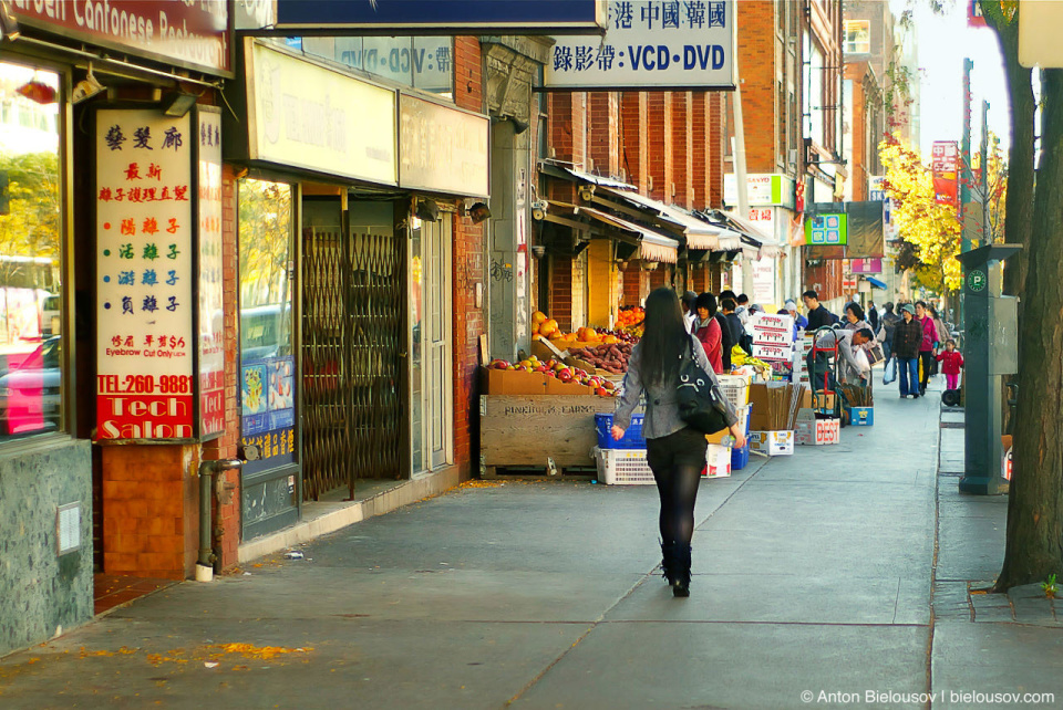 A girl walking sunny morning in Toronto chinatown