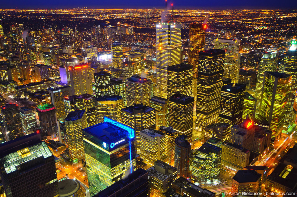 Toronto Downtown Core at night as seen from CN Tower: First Canadian Place skyscraper in the middle, Roy Thompson Hall in bottom left corner